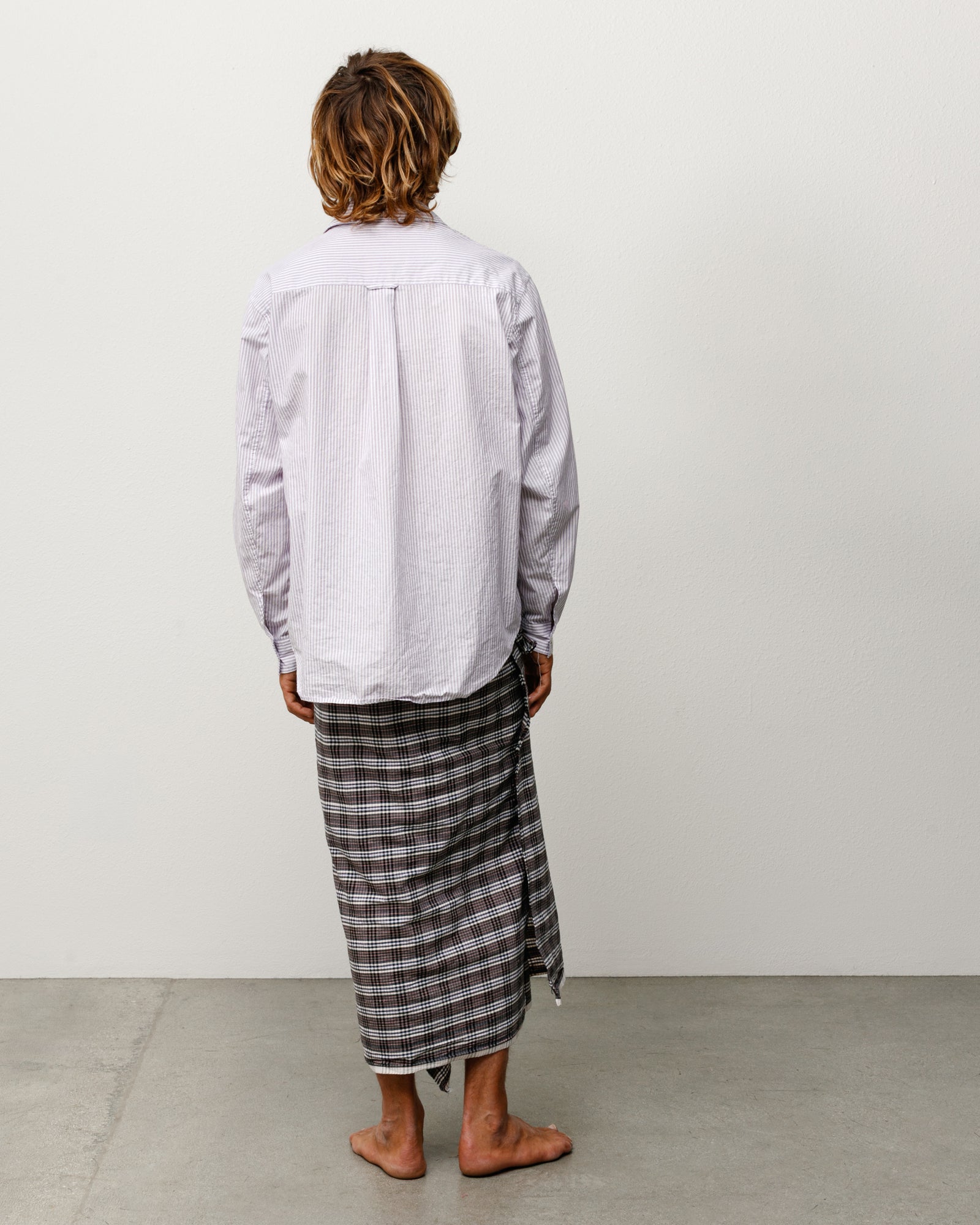 Unisex long-sleeve shirt in purple stripe, back view on model.