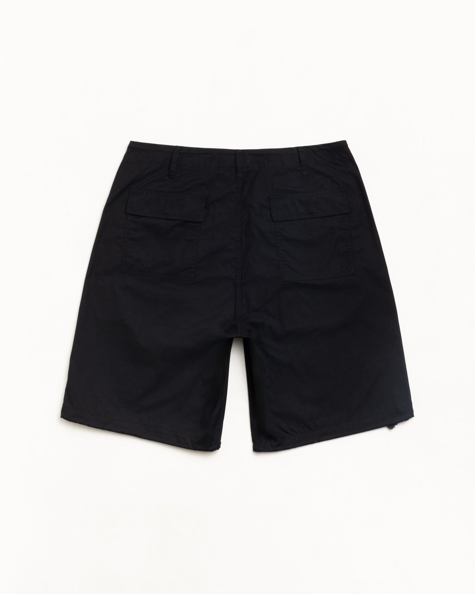 Black utility shorts, back view with dual flap patch pockets, flat lay on white.