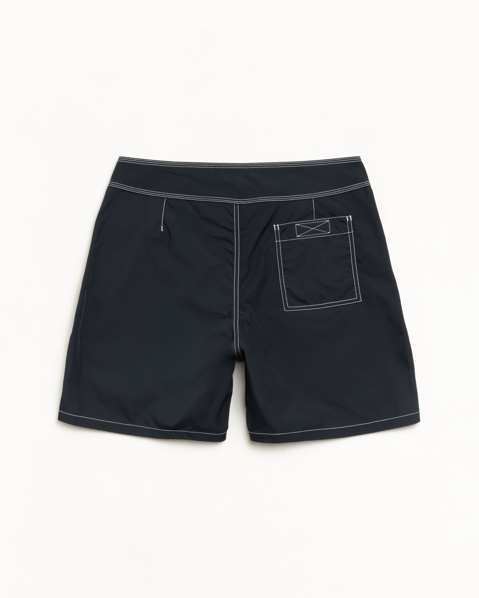 Black board shorts, back view with contrast stitching and rear patch pocket.