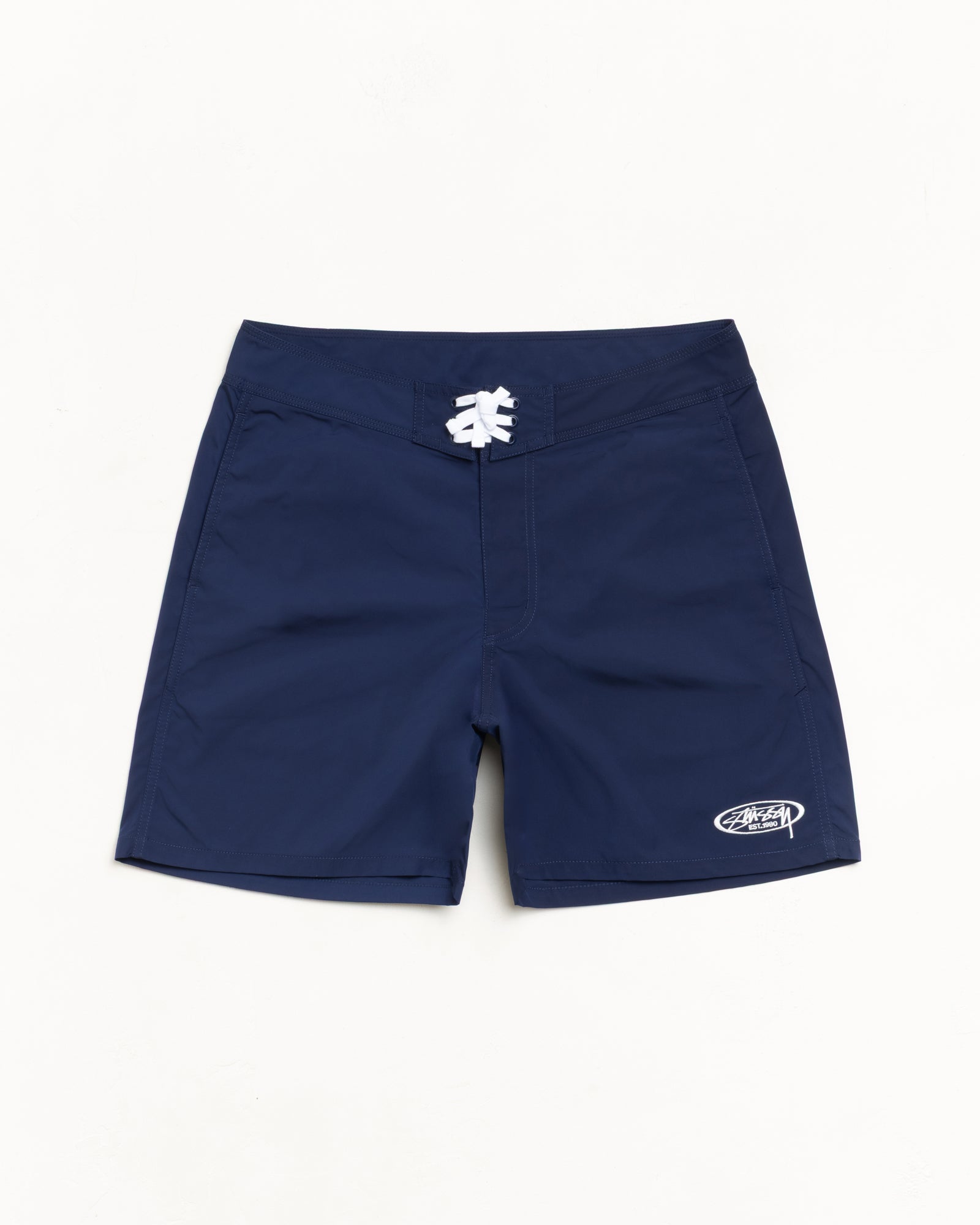 Blue board short with white drawcord and logo at left hem