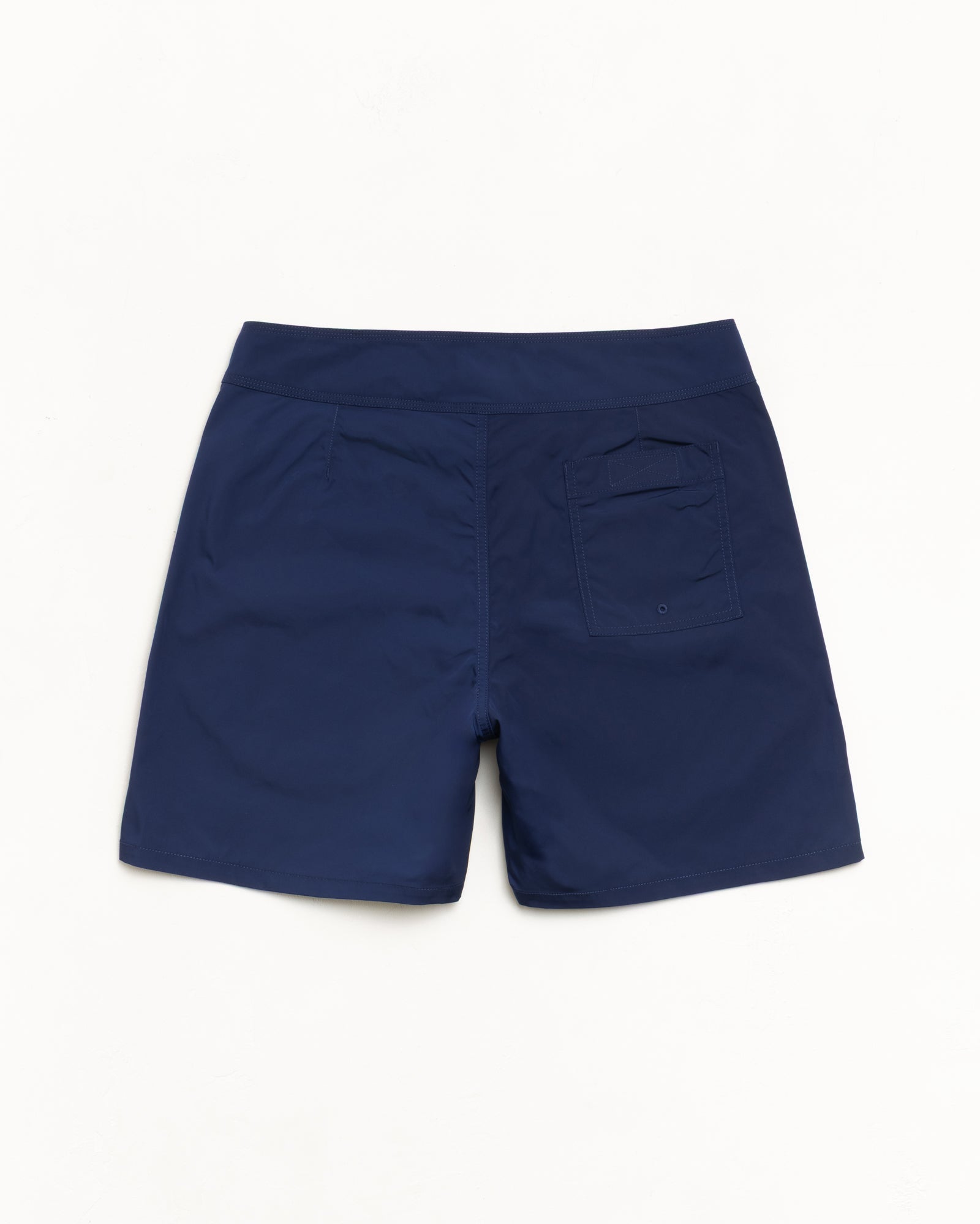 Blue board shorts, back view with rear patch pocket and drainage eyelet