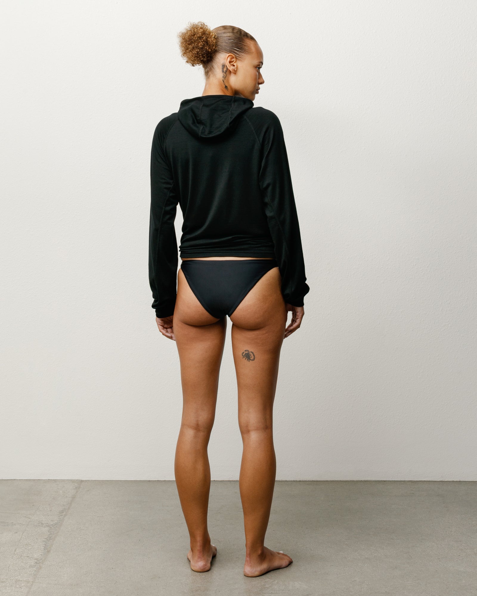 Bikini Bottom Swim in the color Black featuring a mid-rise waist and Stüssy branding