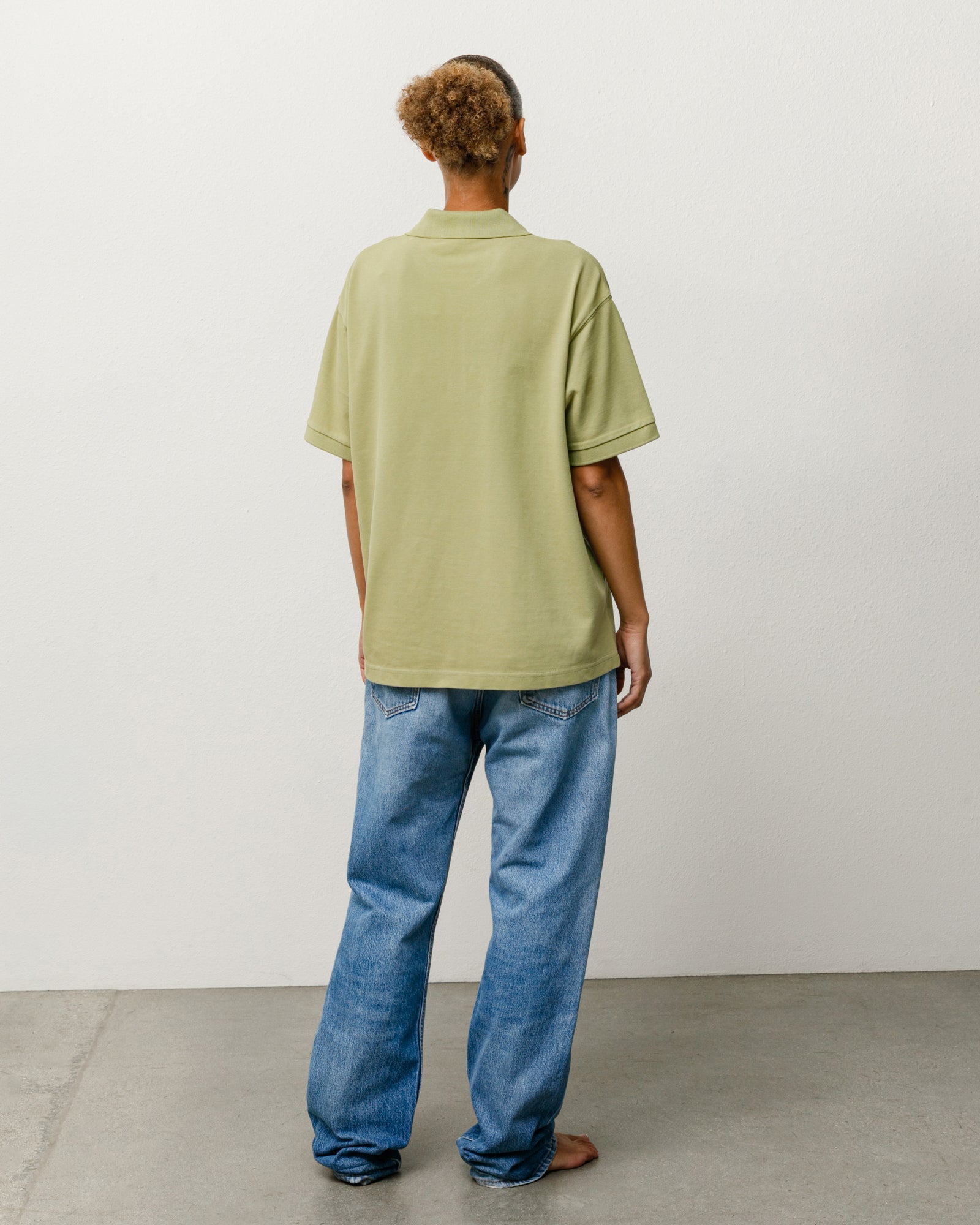 Classic Pique Polo Unisex Short-Sleeve In Leaf, Back View On Model