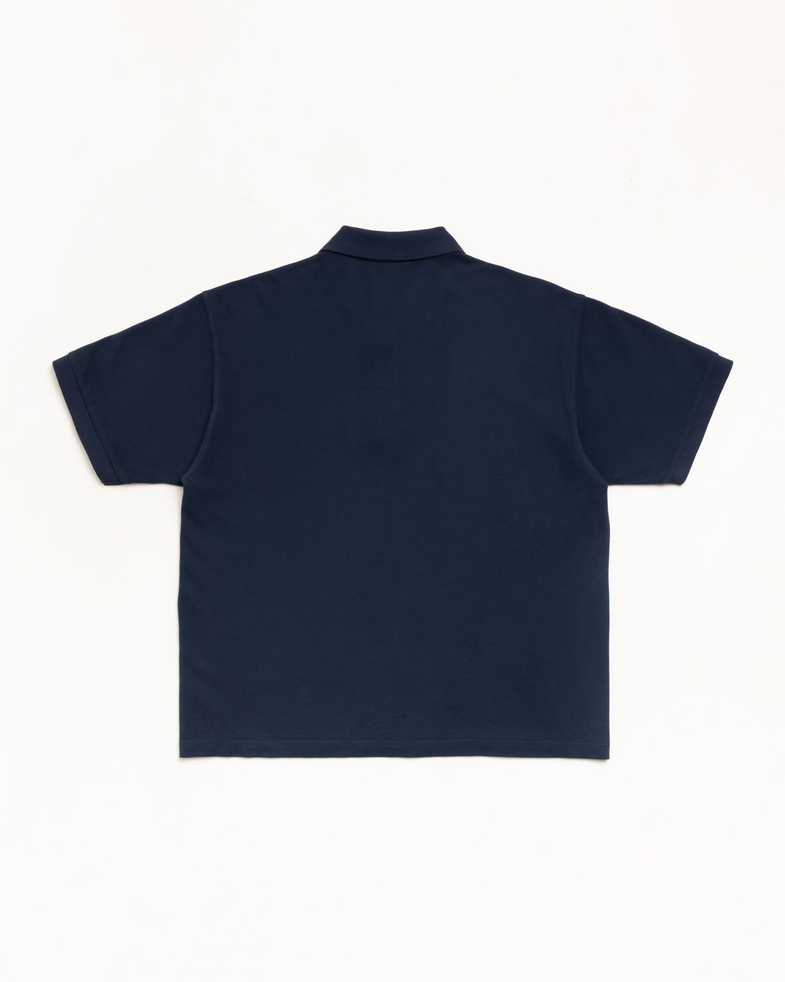 Navy cotton pique polo shirt, short sleeve, back view flat lay