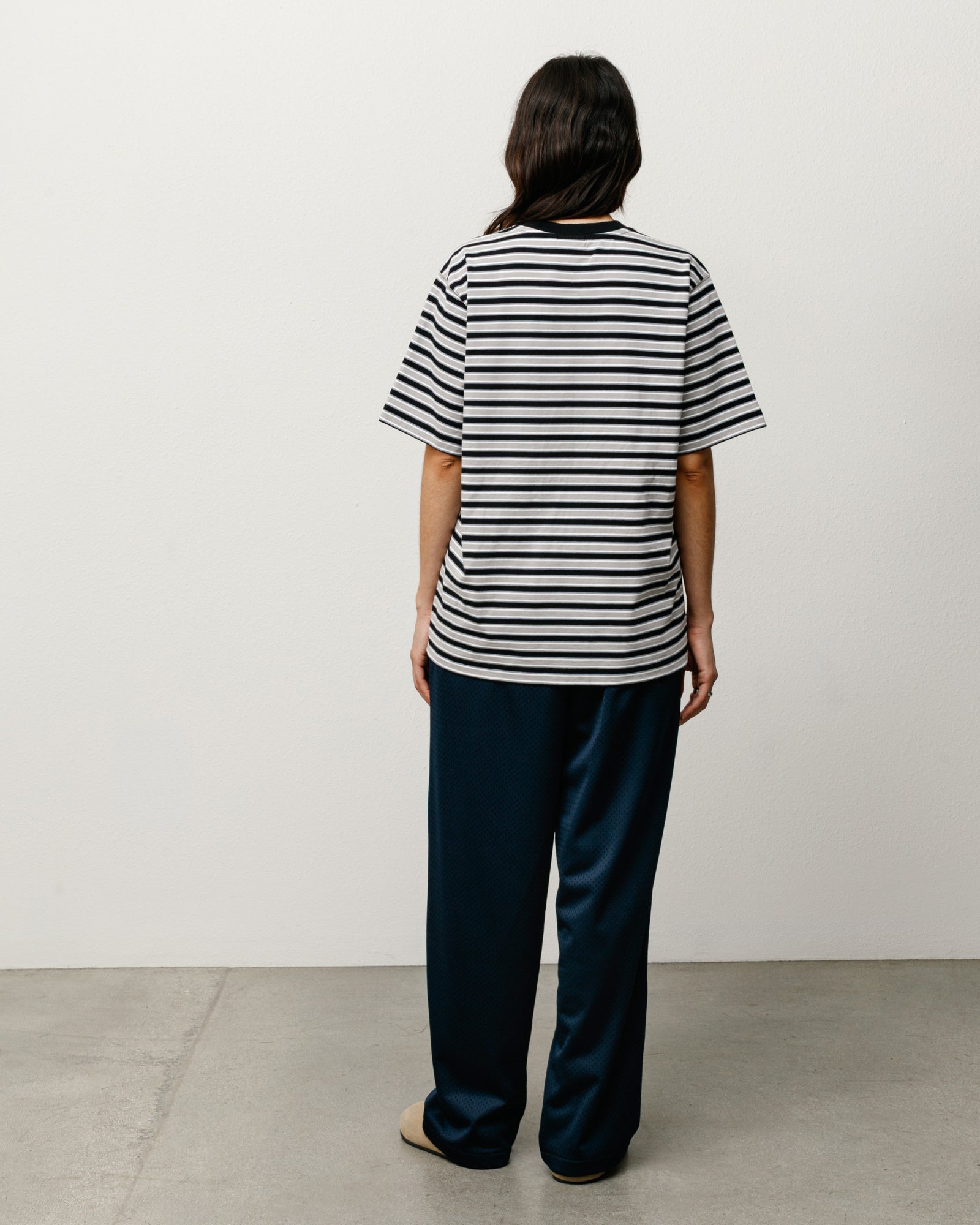 Black and white striped short-sleeve tee, back view on model.