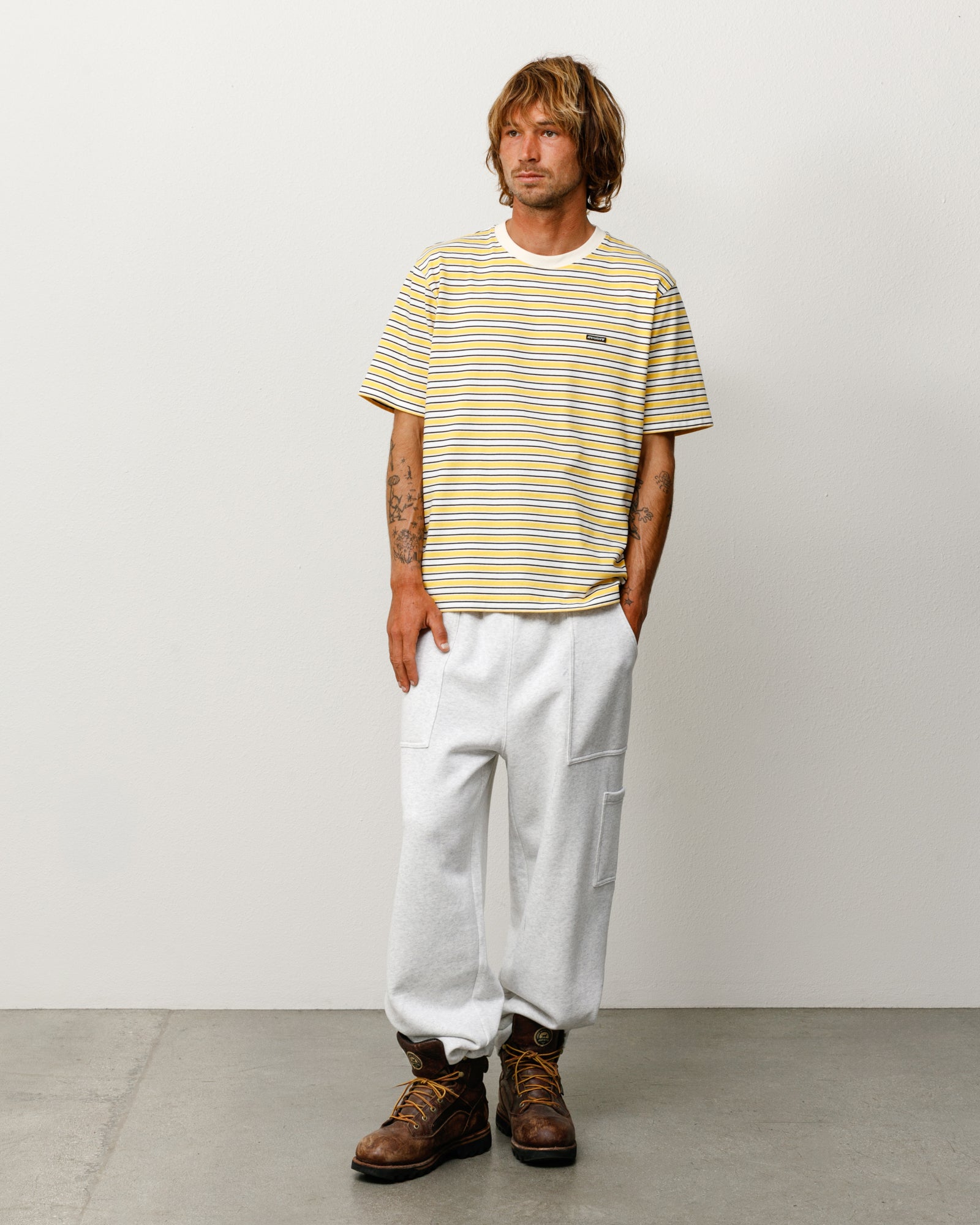 Yellow striped short sleeve tee with ribbed crewneck, relaxed fit, on model