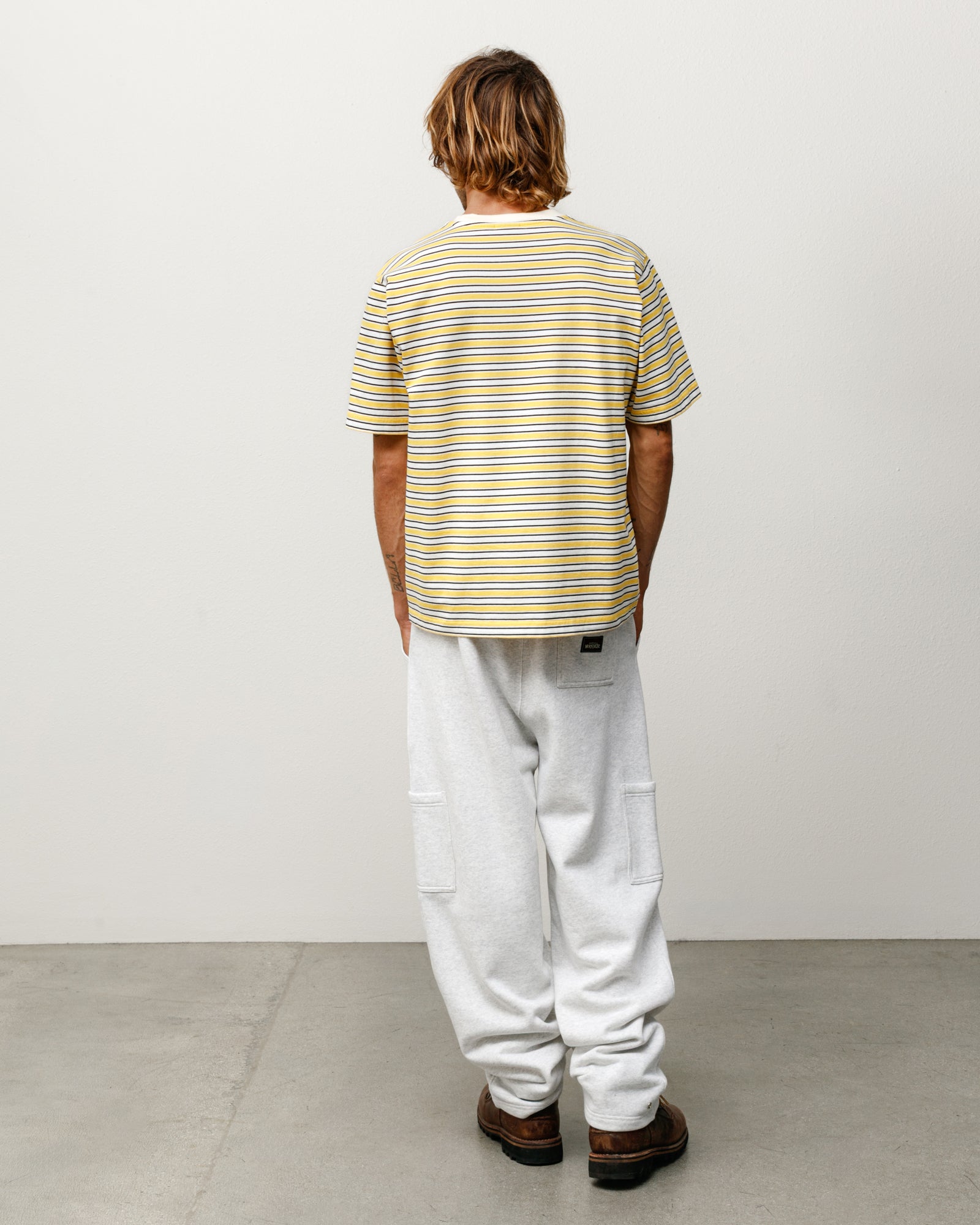 Yellow striped short sleeve tee, back view on model