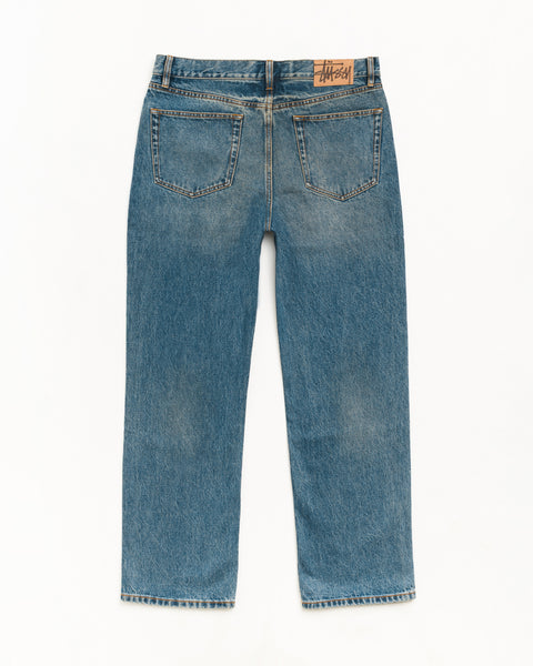 Jean New Classic Denim en Dark Wash Indigo, coupe droite 100 % coton avec patch arrière en suède Stüssy