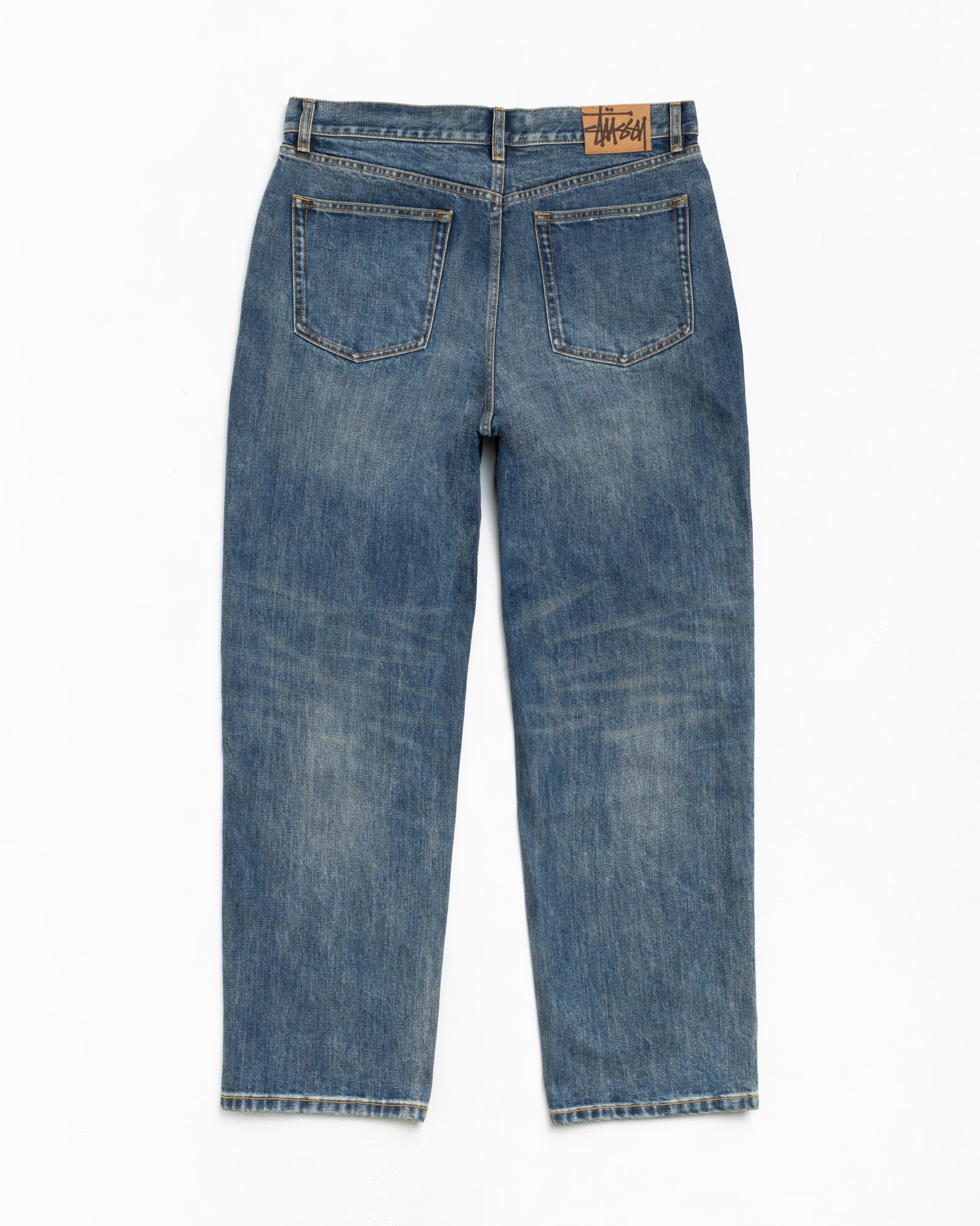 Blue slub denim baggy tapered jeans, back view with five pockets and logo waist patch
