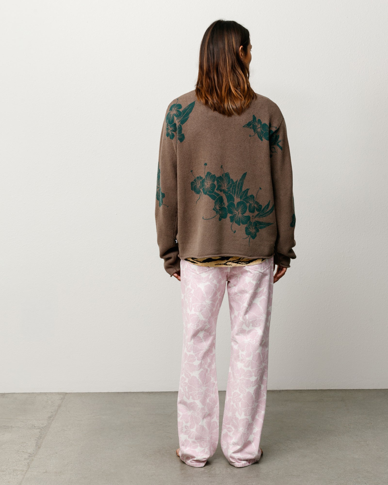 Floral knit sweater unisex long sleeve in brown, back view with green print