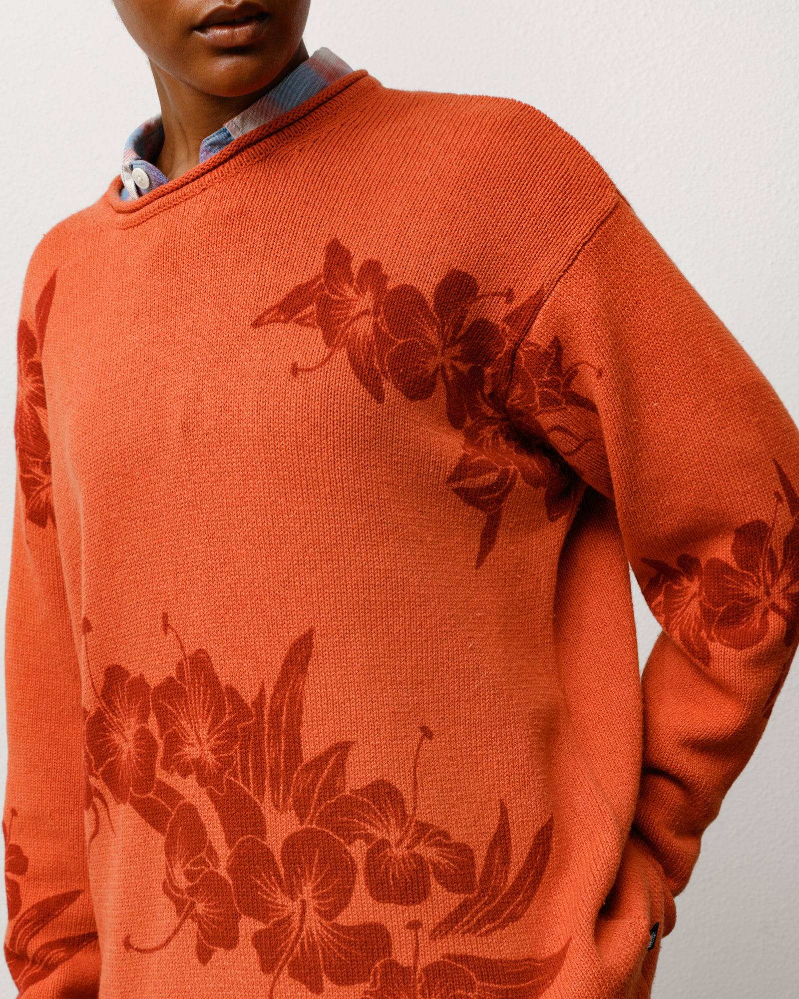 Rust floral roll neck sweater with tonal floral knit and rolled crewneck, on-model close-up.
