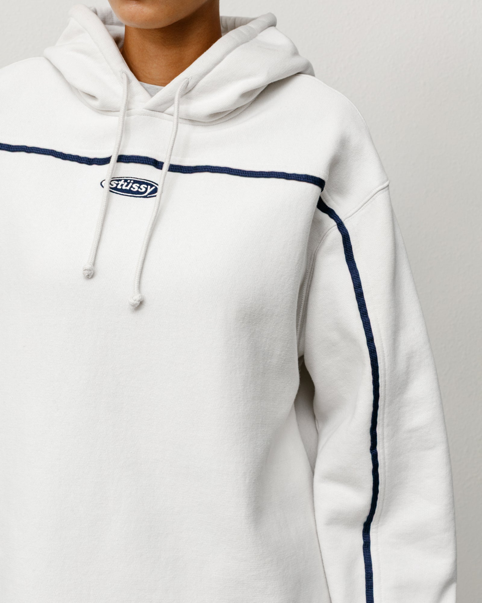 Unisex stone pullover hoodie with navy chest piping and oval Stüssy logo embroidery