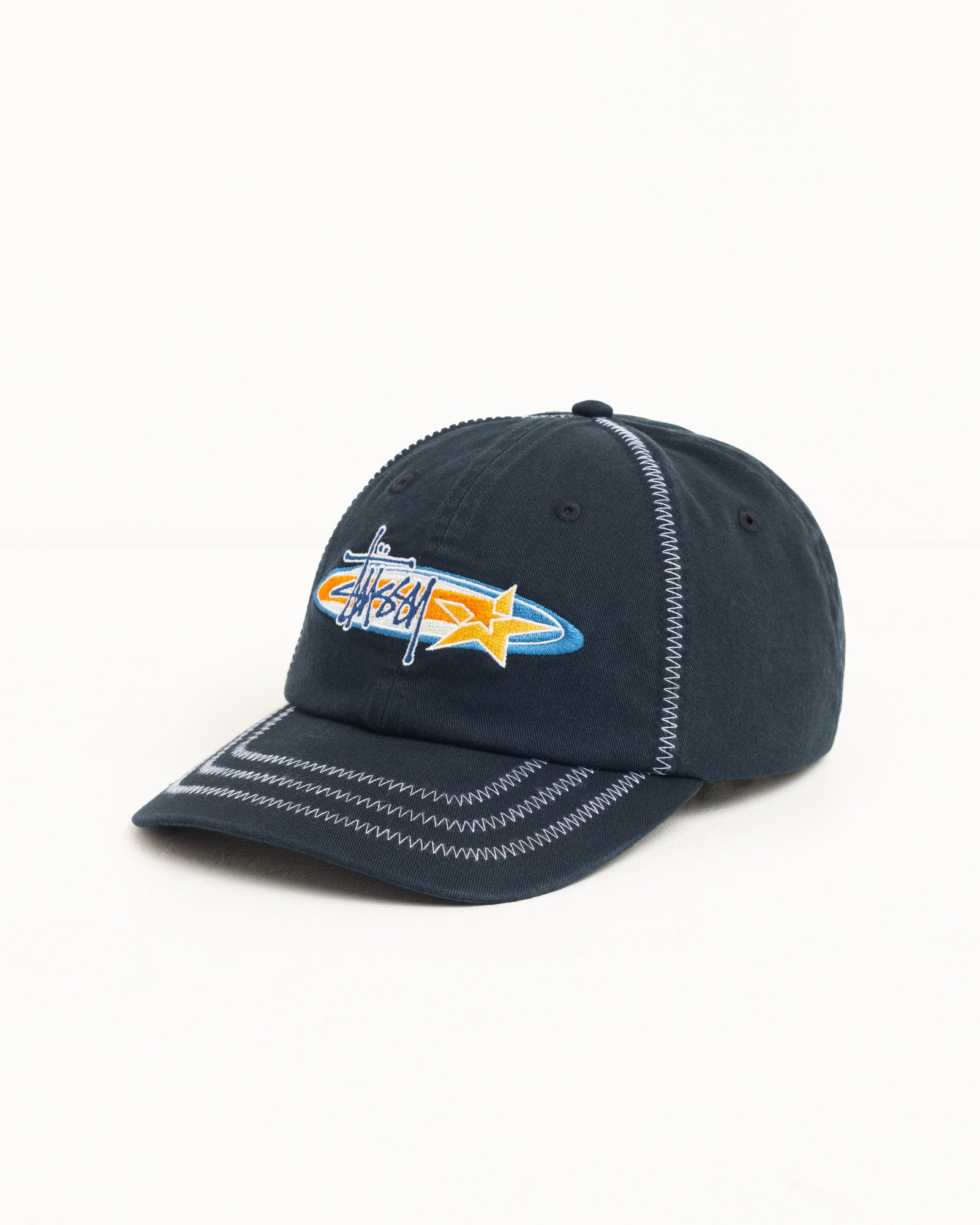 Oval Star Cap Headwear in Black cotton twill with contrast zigzag stitching and Stüssy logo embroidery
