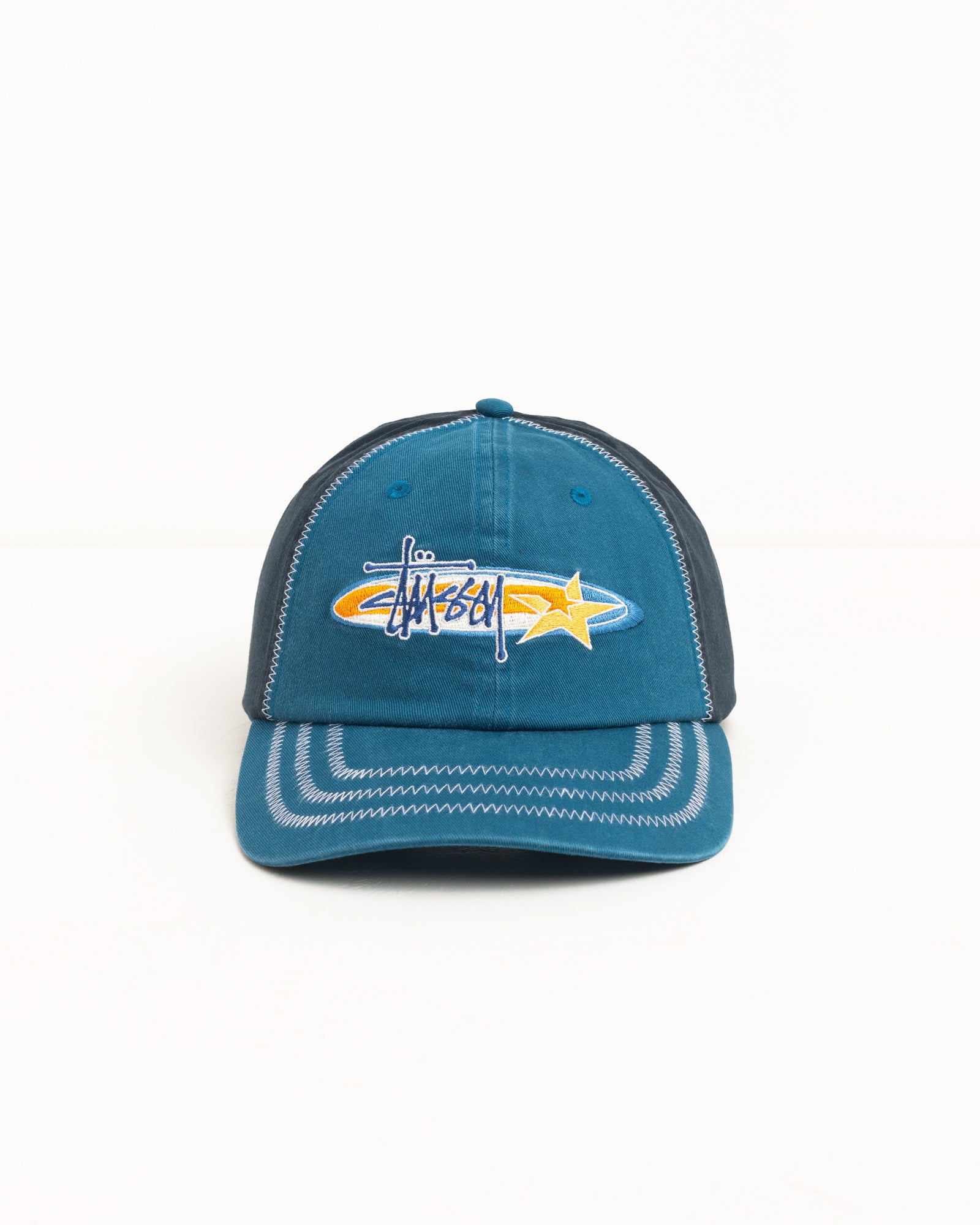 Blue cotton twill cap with Stüssy logo and star embroidery, contrast zigzag stitching