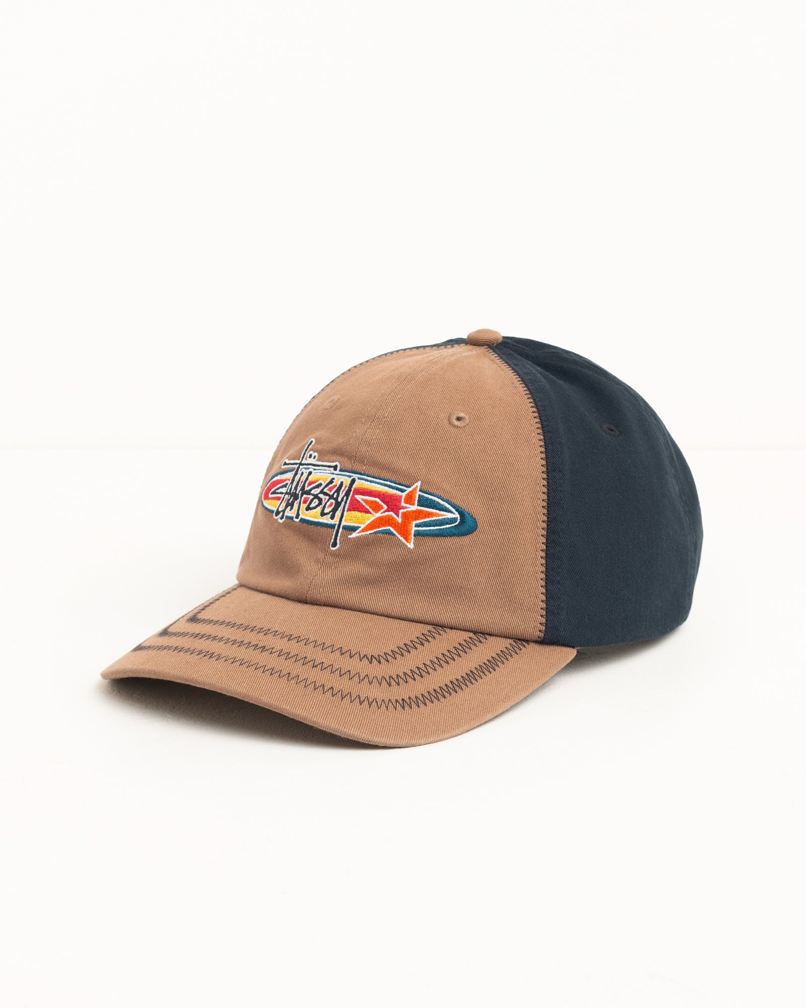 Two-tone brown and navy cotton twill cap with zig-zag brim stitching and oval star logo embroidery