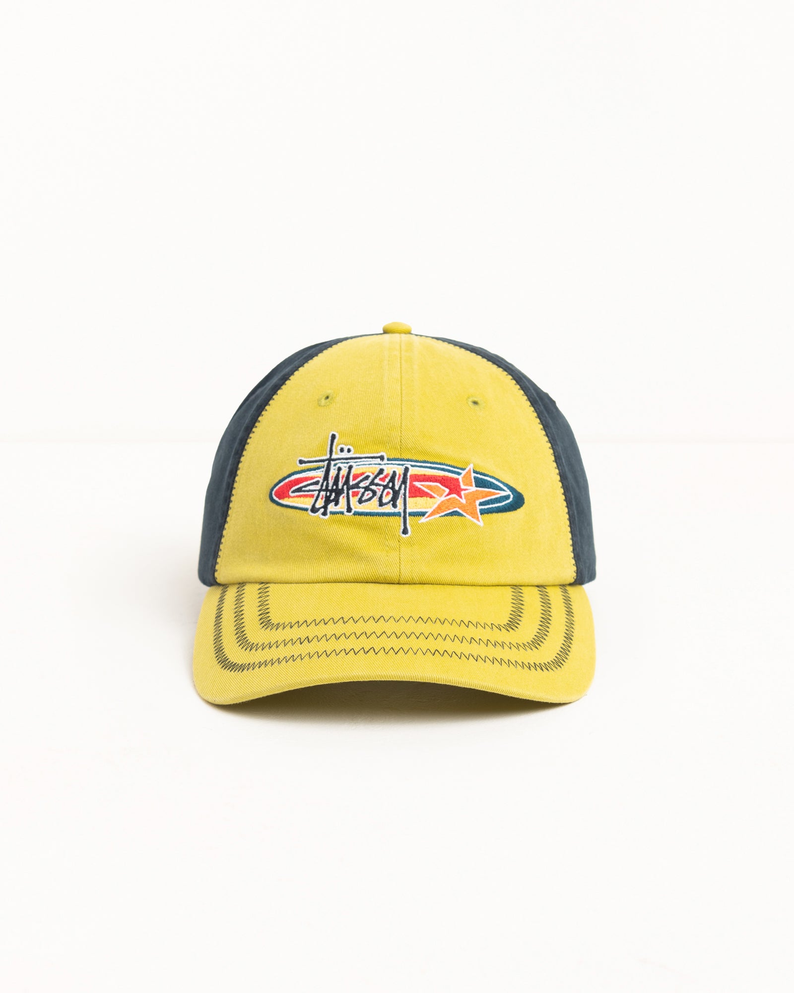 Lime six-panel cap with oval logo and star embroidery, contrast dark panels and zig-zag brim.