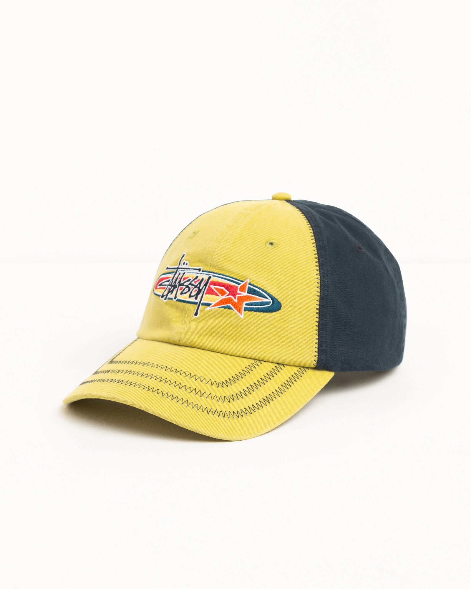 Lime cap with contrast navy panels, zig-zag brim stitching and Stüssy logo embroidery