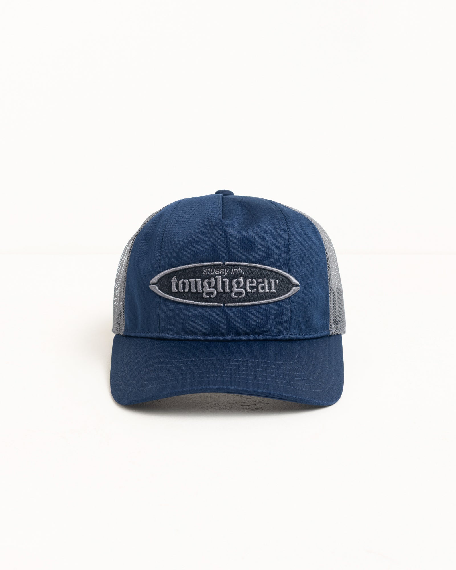 Navy mid-depth trucker cap with grey mesh back and raised Tough Gear logo embroidery