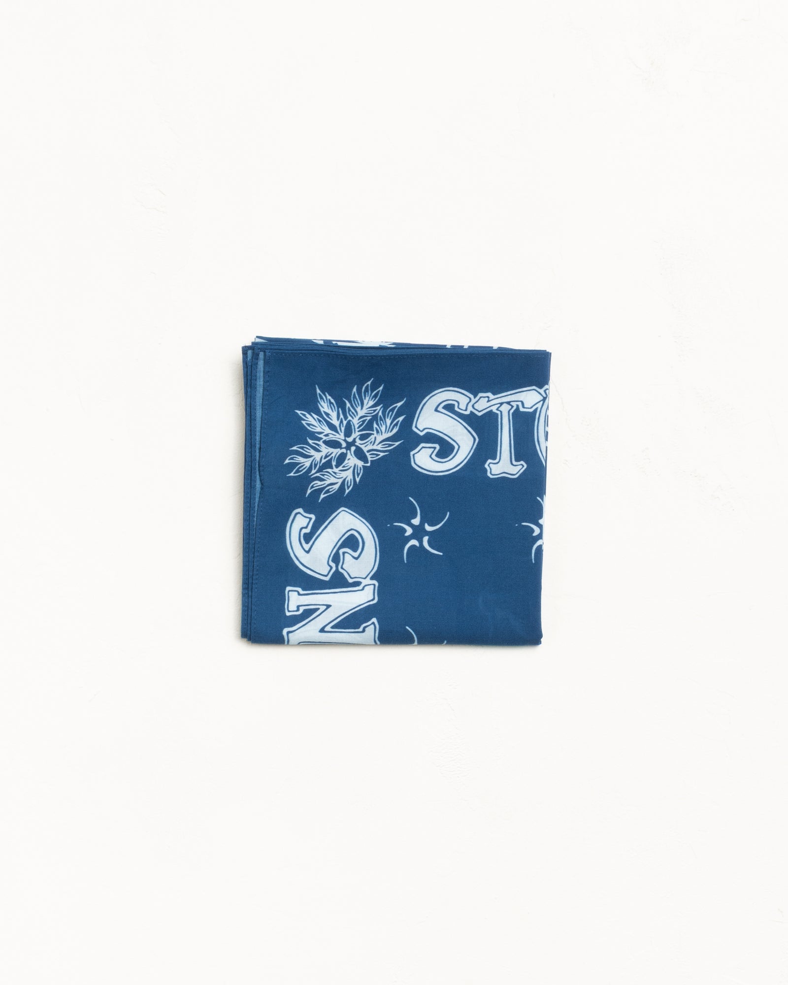 Blue folded bandana with white graphic print details