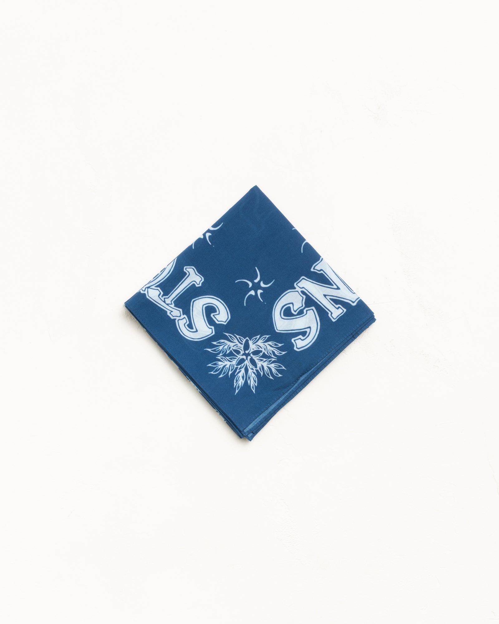 Blue cotton bandana with bold white graphic print, folded for display
