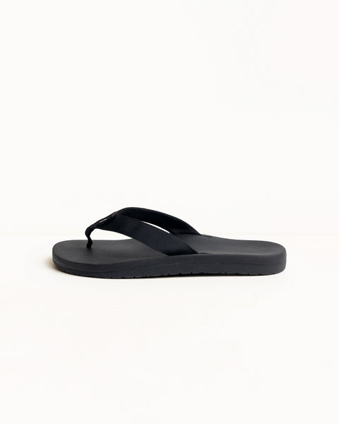 Black rubber flip-flop with wide straps and contoured footbed, side view