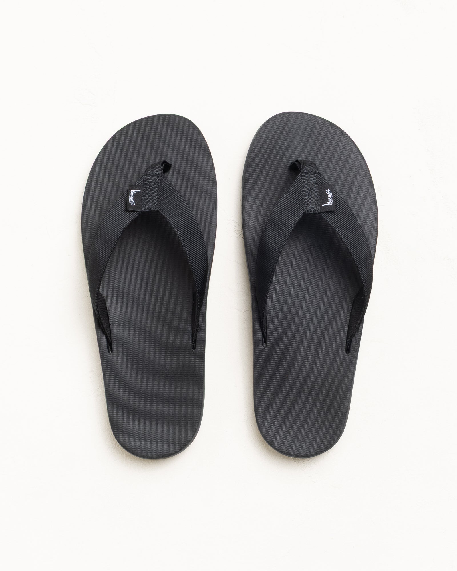 Black Rubber Flip-Flops With Wide Webbing Straps And Textured Footbed