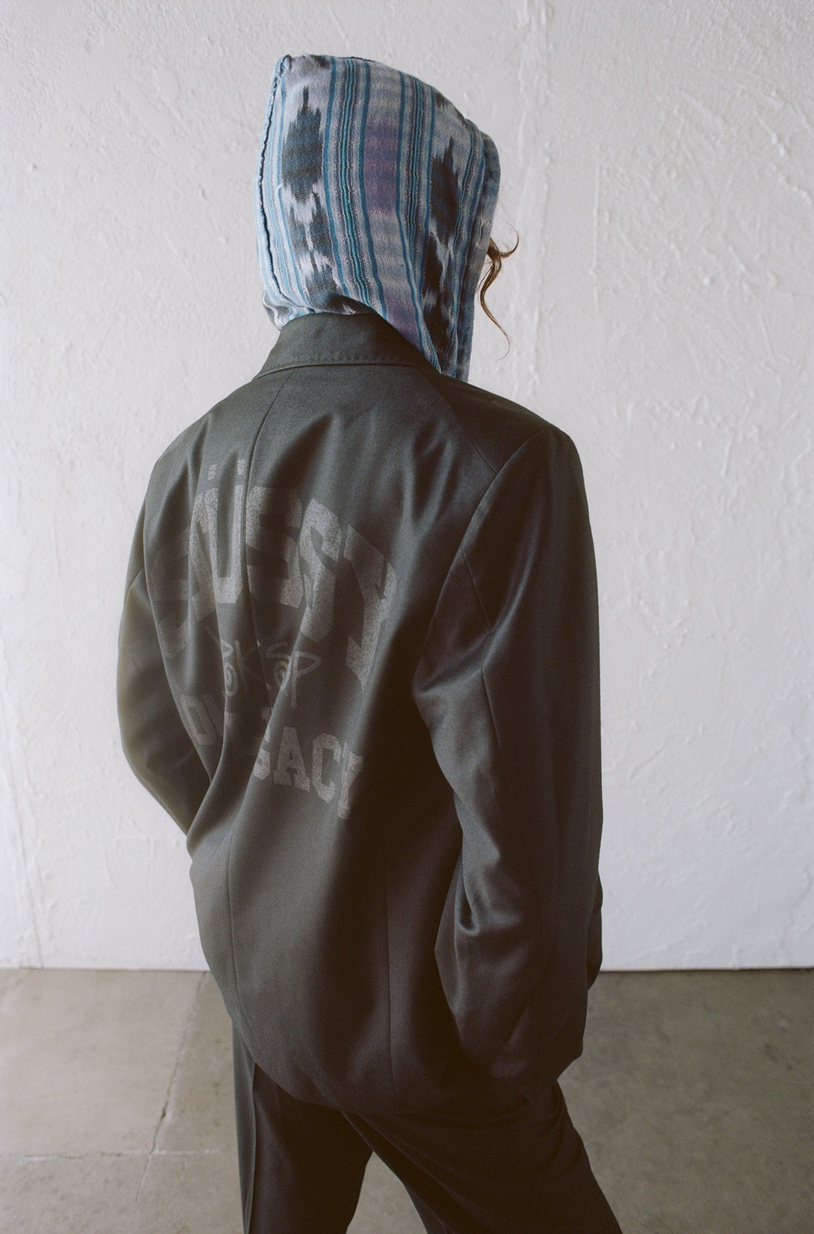 Model wearing the Our Legacy Double-Breasted Blazer in Overdyed from Stussy & Our Legacy Vol. 10. 